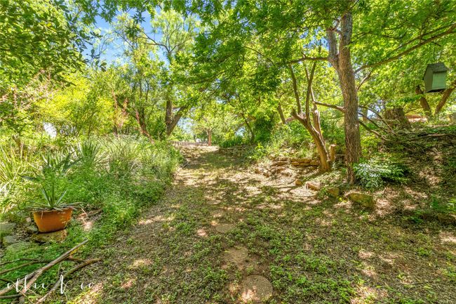I love this home and the way it feels like youe all alone surrounded by nature. Hidden rock path down to the creek | Image 37