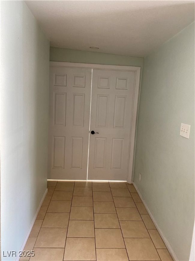 Corridor featuring light tile patterned floors and baseboards | Image 5