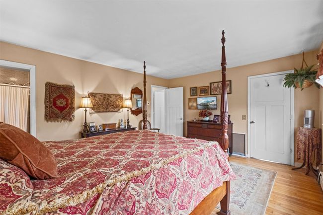 Primary Bedroom with hardwood floors, walk-in closet and bathroom | Image 20