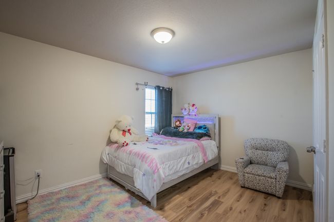 Bedroom with baseboards and wood finished floors | Image 19