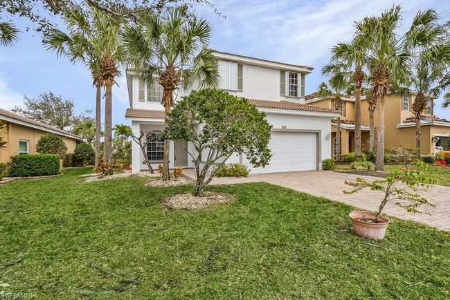 Mediterranean / spanish-style home with a front yard, stucco siding, a tiled roof, decorative driveway, and a garage | Image 32