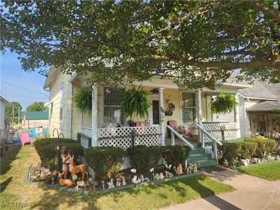 View of front of house featuring covered porch and a front yard | Image 2