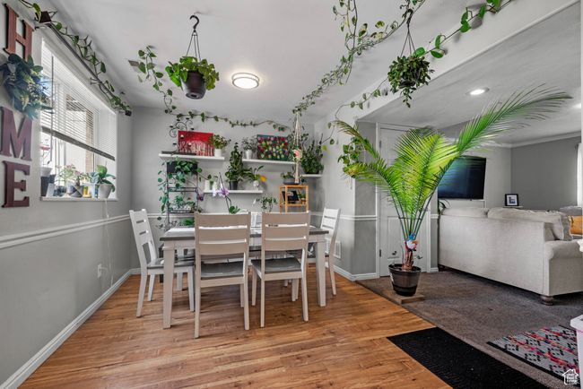 Dining space featuring wood finished floors and baseboards | Image 6