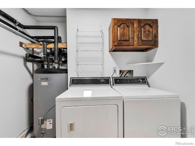 Laundry room on main floor with solar water heater in background | Image 28