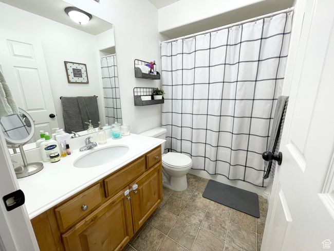 Full primary ensuite bathroom featuring vanity, a shower, and tile patterned flooring | Image 13