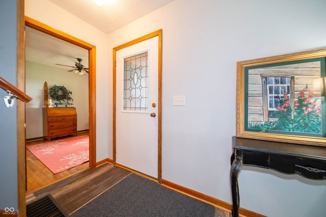 foyer with ceiling fan, baseboards, and wood finished floors | Image 7