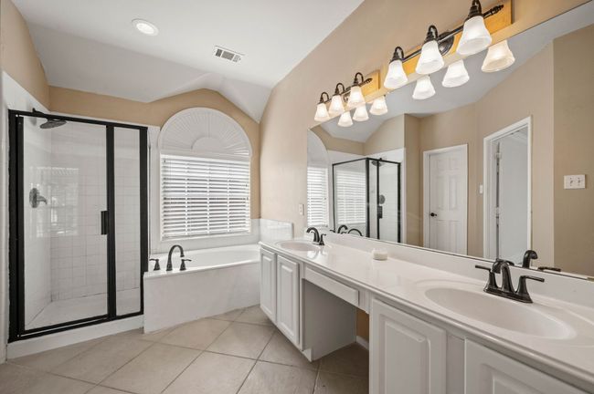 Full bathroom featuring a shower stall, visible vents, a sink, and a bath | Image 23