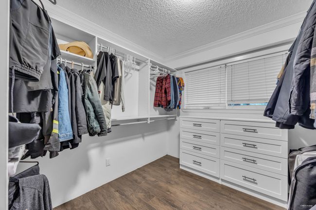 Walk in closet with dark wood-type flooring | Image 19