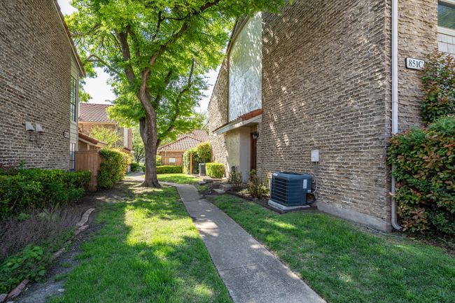 Property exterior with a yard, central AC, and stucco siding | Image 4