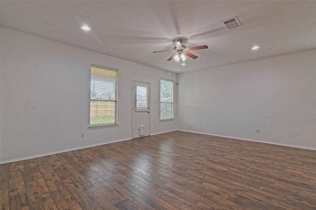 Unfurnished room with dark wood finished floors, ceiling fan, and recessed lighting | Image 7