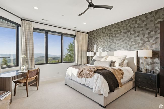 Carpeted bedroom featuring wallpapered walls, recessed lighting, multiple windows, a ceiling fan, and a mountain view | Image 36
