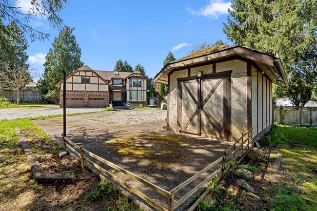 View of shed featuring driveway, fence, and a garage | Image 37