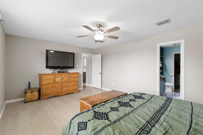 Bedroom featuring light wood finished floors and ceiling fan | Image 13