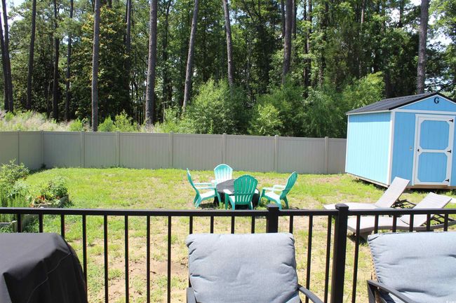 Fenced backyard with a storage unit | Image 4
