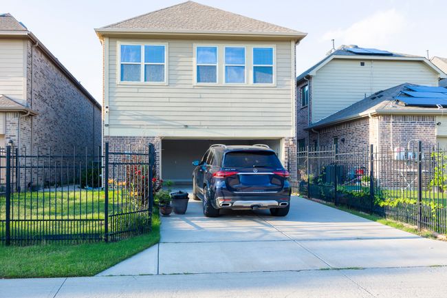 View of front of property featuring concrete driveway, a garage, and brick siding | Image 39