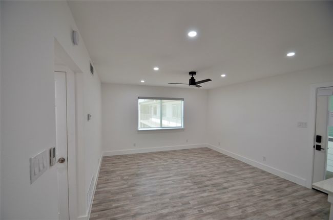 Empty room with recessed lighting, light wood-style floors, and ceiling fan | Image 12