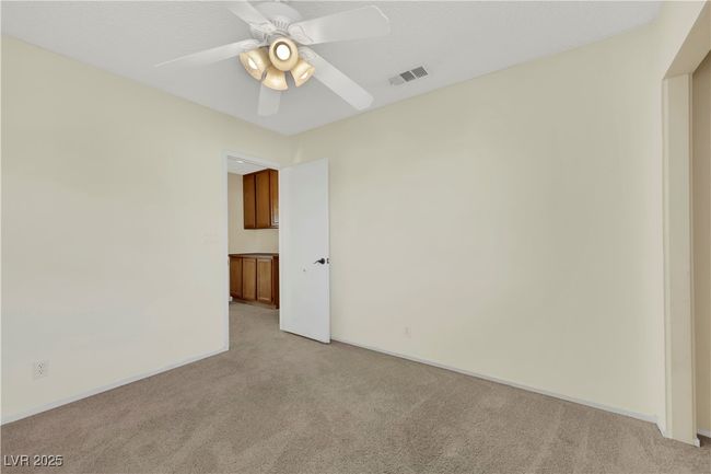 Spare room featuring visible vents, ceiling fan, light carpet, and baseboards | Image 30