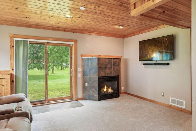 LL family room is a walk out with a cozy gas fireplace. | Image 34