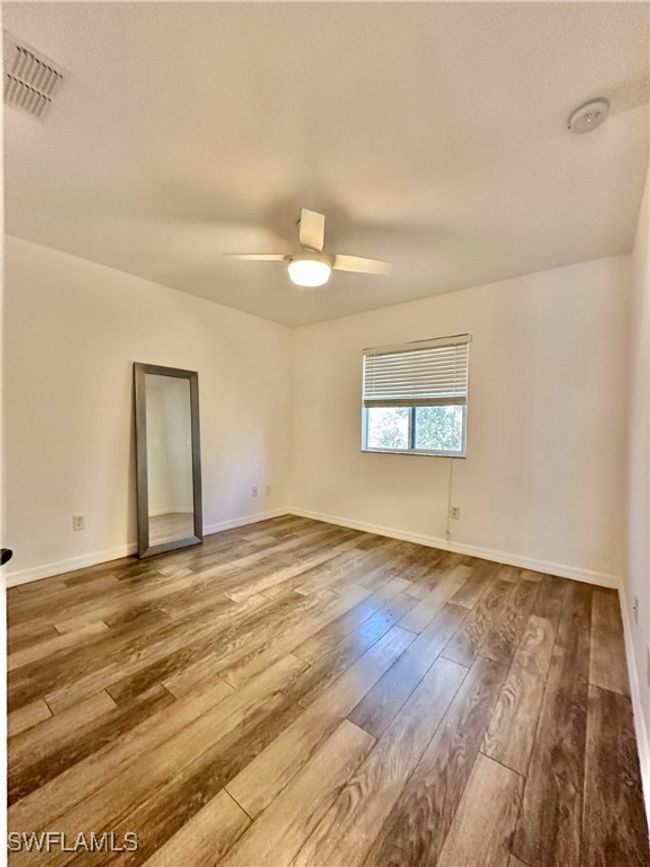 Spare room with ceiling fan and hardwood / wood-style floors | Image 19