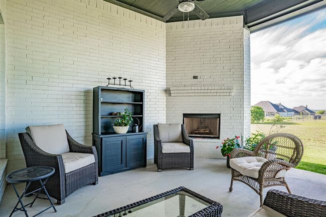 View of patio / terrace featuring an outdoor brick fireplace | Image 34