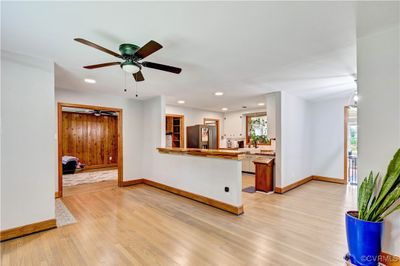 Living room featuring ceiling fan and light hardwood / wood-style flooring | Image 3