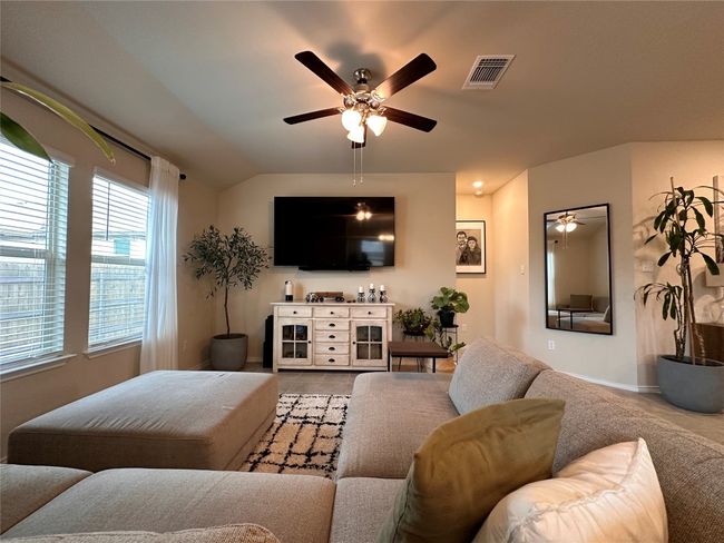 Tiled living area featuring a ceiling fan and baseboards | Image 27