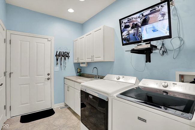 Laundry room has storage, sink and the security system. | Image 34