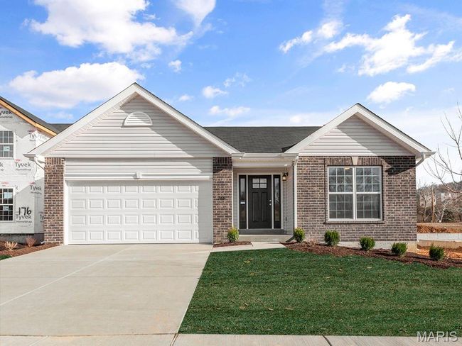 Ranch-style home with brick siding, concrete driveway, a garage, and a front yard | Image 24