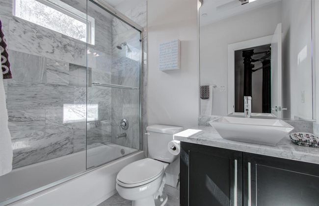 Granite countertops and modern details in the 1st floor ensuite bathroom. | Image 12
