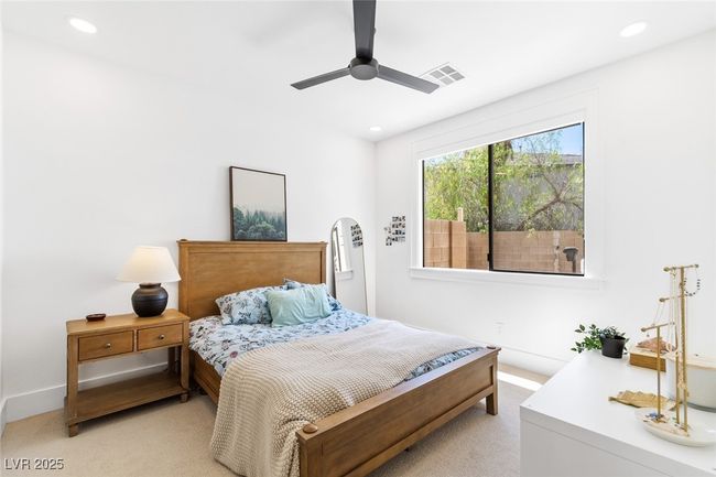Bedroom with light colored carpet, ceiling fan, visible vents, and recessed lighting | Image 9