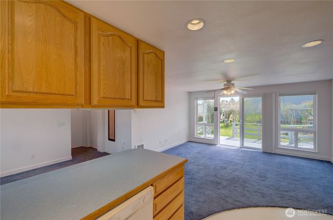Apartment living, kitchen and dining area. The sliding door takes you to the rear deck and fully fenced, landscaped back yard. | Image 29