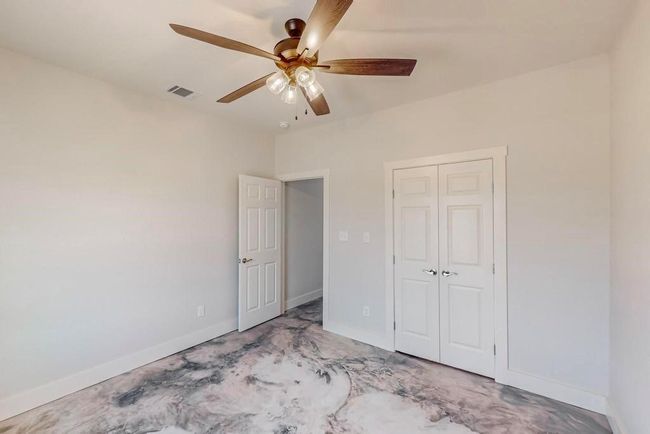 Unfurnished bedroom with visible vents, baseboards, a ceiling fan, and a closet | Image 23