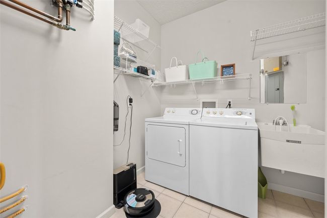 A guest bathroom also has white cabinets and large vanity. | Image 32