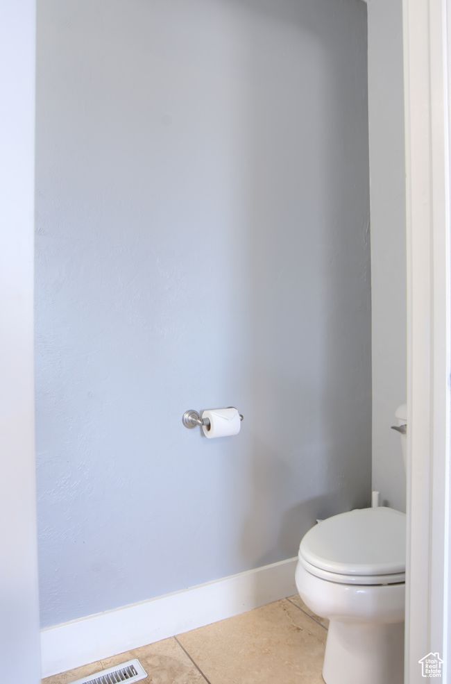 Bathroom featuring toilet, tile patterned floors, and baseboards | Image 39