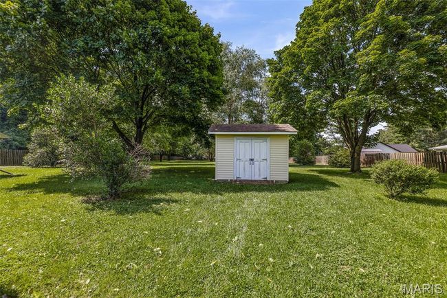 Fenced backyard featuring a shed | Image 9