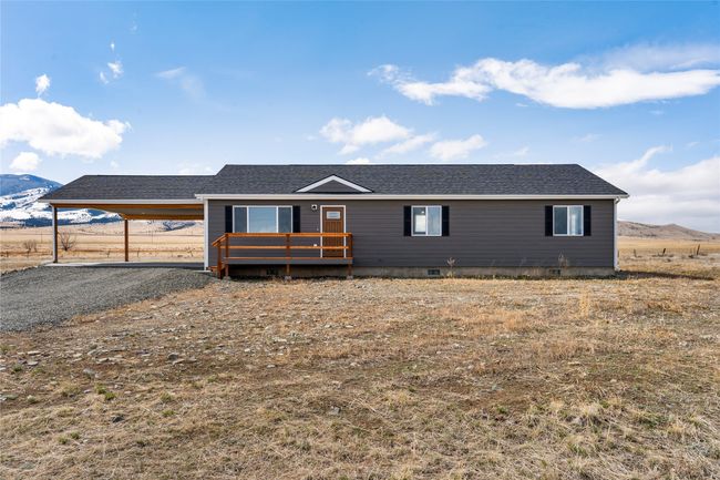 View of front of house with a deck with mountain view, crawl space, and roof with shingles | Image 20