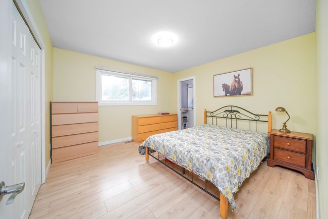 Bedroom featuring light wood-style flooring, baseboards, and a closet | Image 15