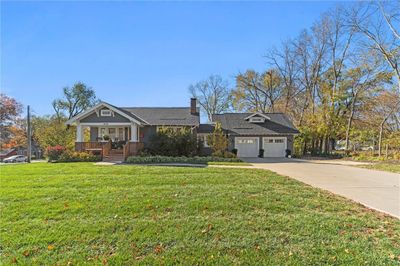 View of front of property with a front lawn, covered porch, and an attached double garage | Image 1