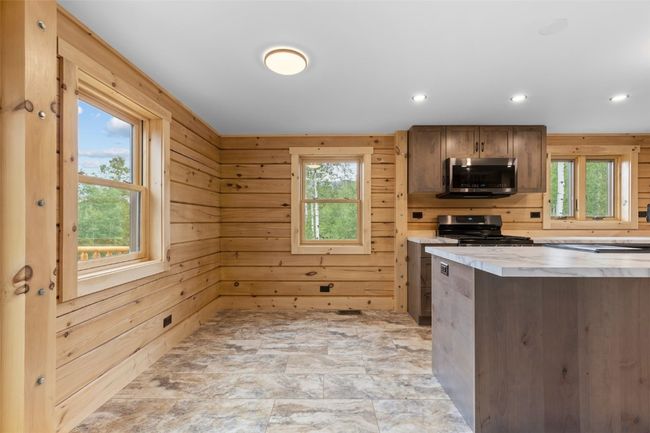 Dining nook featuring a wealth of natural light, light tile floors | Image 18