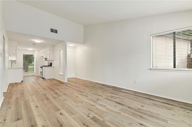 Unfurnished living room with light wood-style floors and baseboards | Image 4