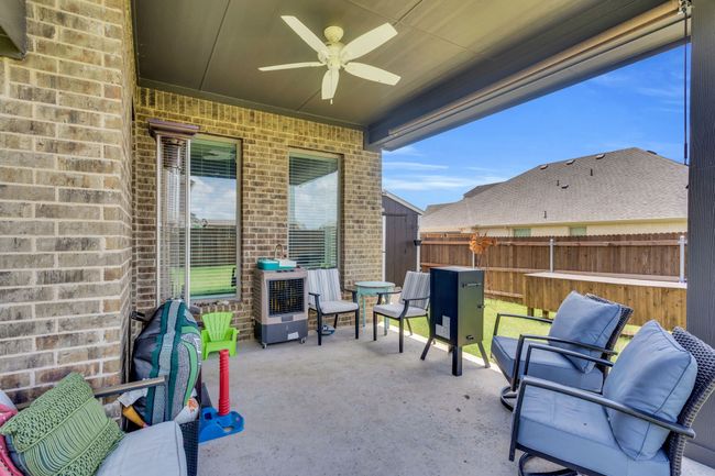 View of property exterior with concrete driveway, brick siding, a garage, roof with shingles, and stone siding | Image 33