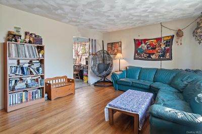 Living room featuring hardwood / wood-style floors and a textured ceiling | Image 3