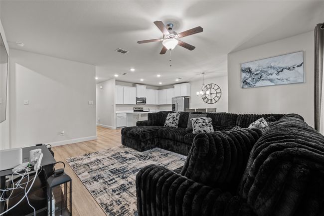 Living area featuring ceiling fan, a chandelier, light wood-style flooring, baseboards, and recessed​​‌​​​​‌​​‌‌​‌‌​​​‌‌​​‌‌​‌​​​​​‌ lighting | Image 10