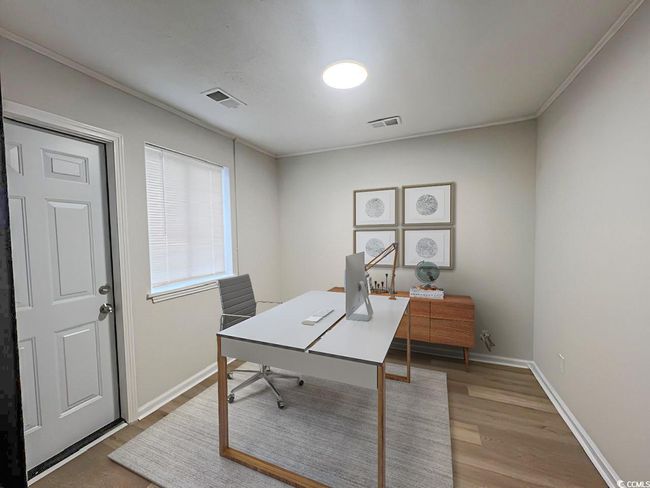 Office space featuring baseboards, crown molding, visible vents, and wood finished floors | Image 11