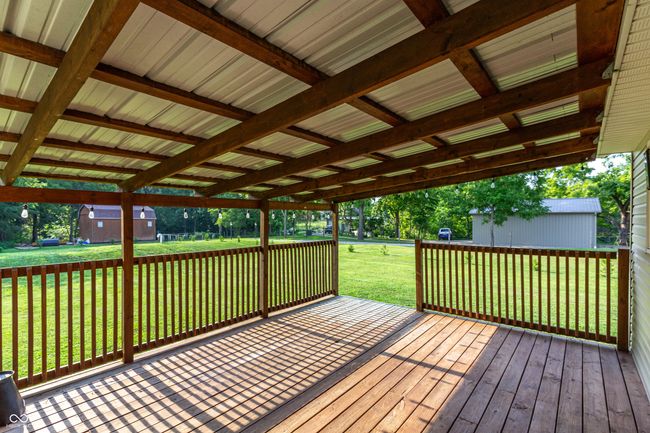 Covered rear deck is a great space to relax and unwind. | Image 18