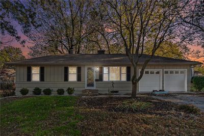 Single story home featuring a garage and a lawn | Image 1