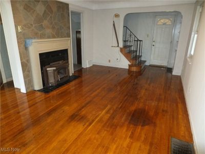 Unfurnished living room featuring dark hardwood / wood-style floors | Image 2