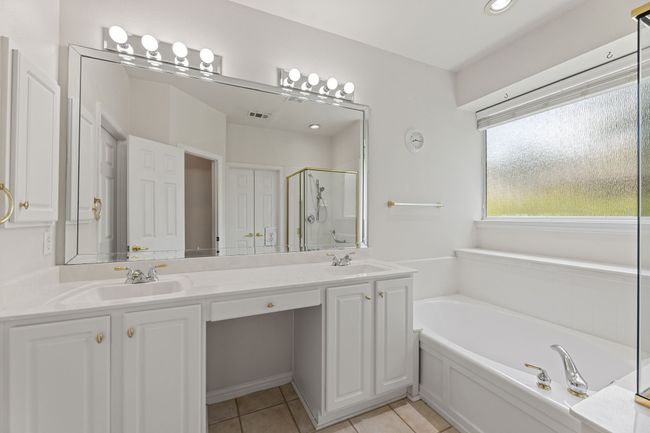 Full bathroom featuring double vanity, a garden tub, a shower stall, tile patterned flooring, and recessed lighting | Image 30
