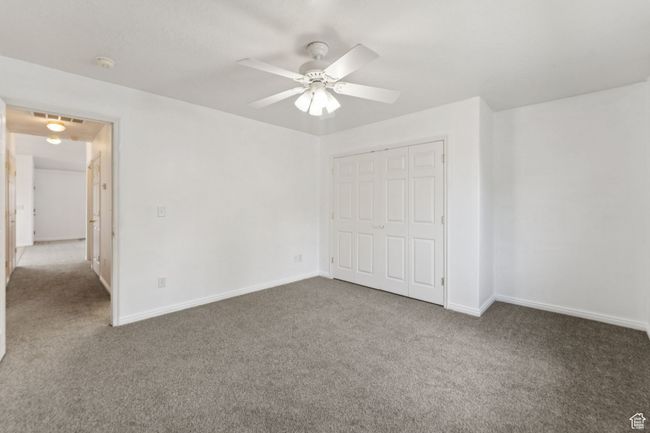 Unfurnished bedroom featuring carpet flooring, a closet, and ceiling fan | Image 14