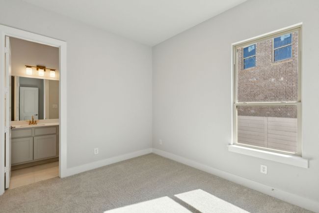 Ensuite bedroom featuring carpet floors and ensuite bath | Image 22